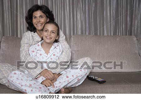 Mother and daughter watching TV View Large Photo Image Stock Image - Mother and daughter watching TV. Fotosearch