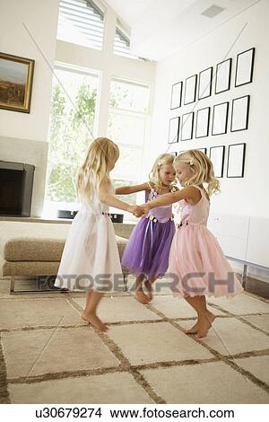 Triplets dancing in living room View Large Photo Image Picture - Triplets dancing in living room. Fotosearch