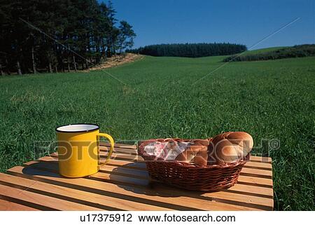 Stock Image - Bread And Mug On Picnic Table. Fotosearch