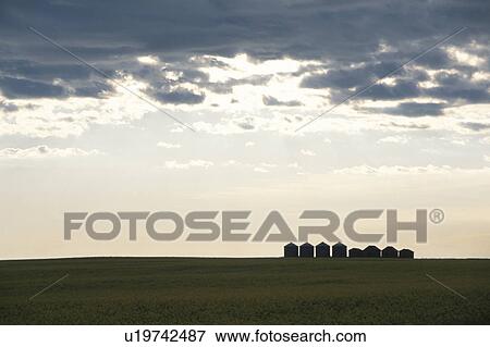 Stock Photo - The Sunset And A Silo In Canada. Fotosearch