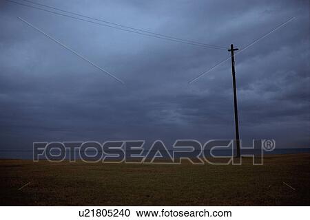 Stock Image - Utility Pole In Field. Fotosearch