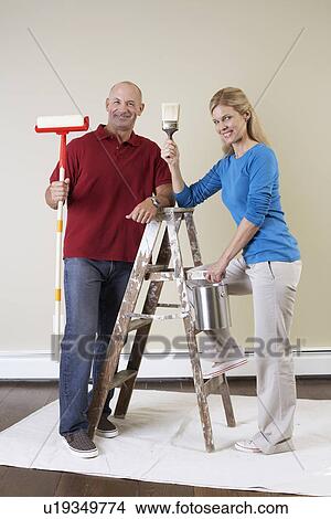 Mature couple decorating home View Large Photo Image Picture - Mature couple decorating home. Fotosearch