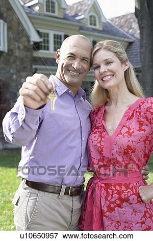 Stock Photo - Mature couple holding house key, Chatham, New Jersey, USA. Fotosearch