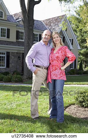 Stock Photo - Mature couple near house, Chatham, New Jersey, USA. Fotosearch