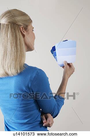 Mature woman looking at color swatches View Large Photo Image Stock Image - Mature woman looking at color swatches. Fotosearch