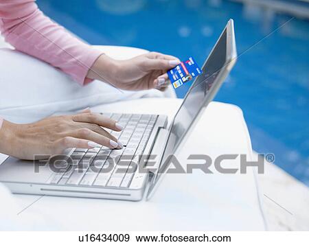 Woman entering credit card details online (close-up) View Large Photo Image Stock Photo - Woman entering credit card details online (close-up). Fotosearch