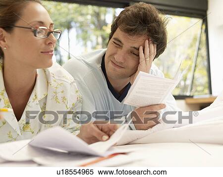 Young couple looking at bills View Large Photo Image Stock Photography - Young couple looking at bills. Fotosearch