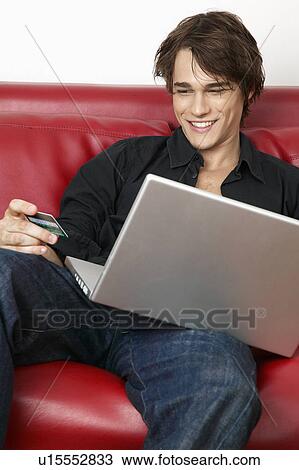Stock Image - Young Man Internet Shopping. Fotosearch