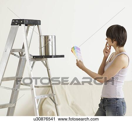 Young Woman Looking at Color Swatches View Large Photo Image Stock Image - Young Woman Looking at Color Swatches. Fotosearch
