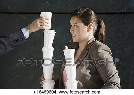Person's hand stacking takeout coffees on woman's hands View Large Photo Image Picture - Person's hand stacking takeout coffees on woman's hands. Fotosearch