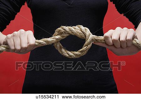 Person's hands tying knot (close-up) View Large Photo Image Stock Image - Person's hands tying knot (close-up). Fotosearch