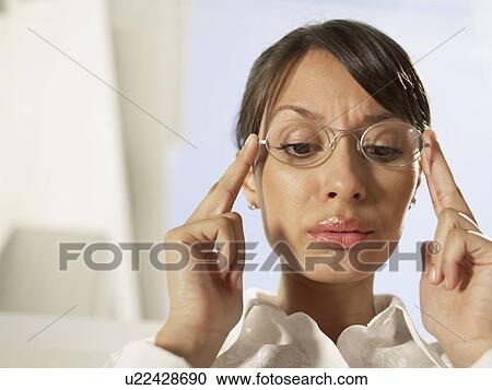 Woman holding eyeglasses and looking down View Large Photo Image Stock Image - Woman holding eyeglasses and looking down. Fotosearch