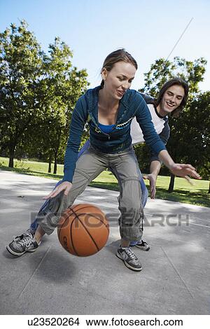 Young couple playing basketball View Large Photo Image Picture - Young couple playing basketball. Fotosearch