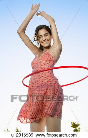 Stock Photo - Young woman with hula hoop. Fotosearch