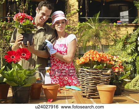 Stock Photograph - Couple planting flowers. Fotosearch