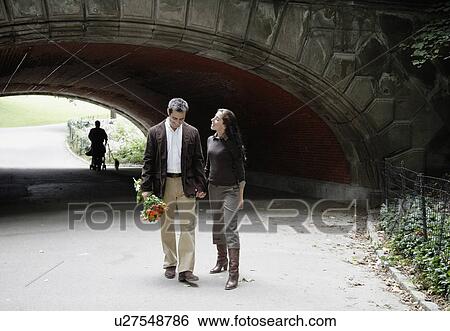 Stock Photograph - Couple walking in park. Fotosearch