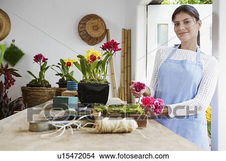 Picture - Female florist arranging flowers. Fotosearch