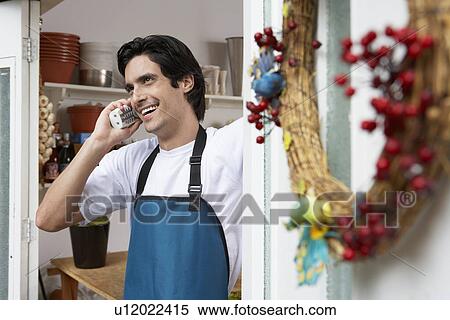 Stock Photography - Male florist on phone. Fotosearch