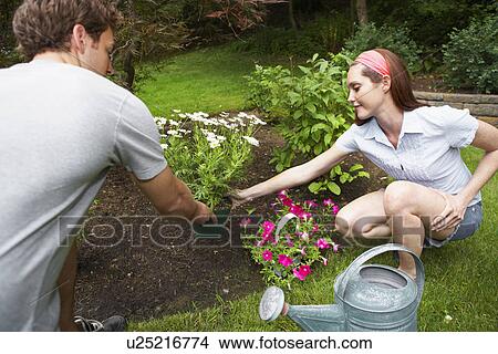 Picture - Man and woman planting flowers. Fotosearch