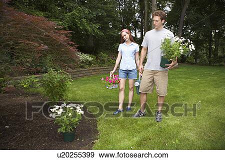 Stock Photo - Man and woman planting flowers. Fotosearch