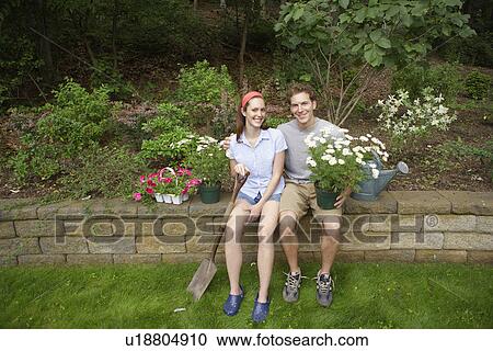 Young couple in garden (portrait) View Large Photo Image Stock Image - Young couple in garden (portrait). Fotosearch