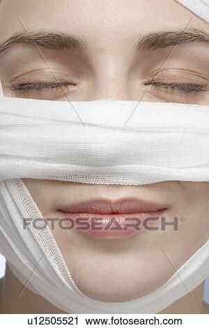 Bandage around woman's face, close-up View Large Photo Image Stock Image - Bandage around woman's face, close-up. Fotosearch