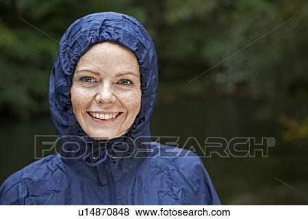 Stock Photo - Mid Adult Woman Wearing Raincoat. Fotosearch