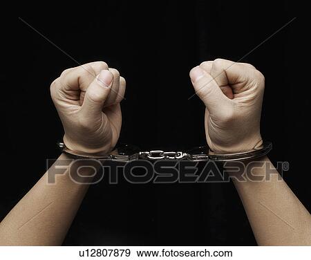 Stock Photo - Person in Handcuffs. Fotosearch