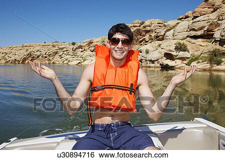 Young man in life jacket View Large Photo Image Stock Photograph - Young man in life jacket. Fotosearch