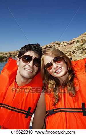Young woman wearing life jackets View Large Photo Image Stock Image - Young woman wearing life jackets. Fotosearch