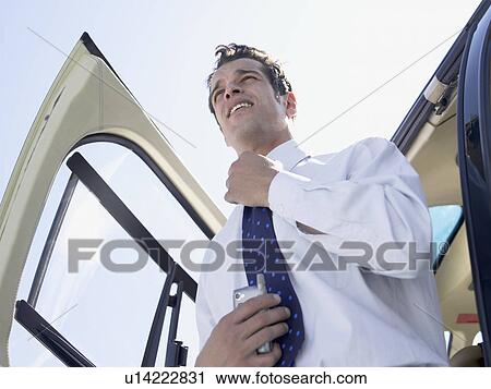 Businessman disembarking helicopter (low angle view) View Large Photo Image Stock Image - Businessman disembarking helicopter (low angle view). Fotosearch