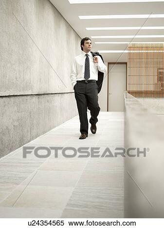 Businessman walking in corridor View Large Photo Image Stock Photography - Businessman walking in corridor. Fotosearch