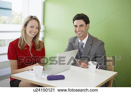 Businesswoman and businessman using laptop at cafe View Large Photo Image Stock Image - Businesswoman and businessman using laptop at cafe. Fotosearch