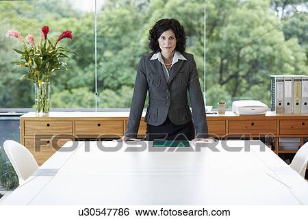 Stock Photograph - Businesswoman in conference room. Fotosearch
