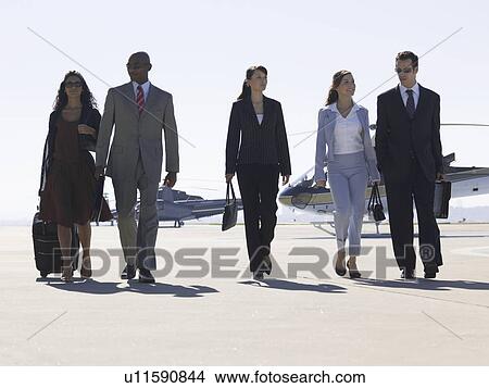 Five businesspeople walking near helicopters View Large Photo Image Picture - Five businesspeople walking near helicopters. Fotosearch