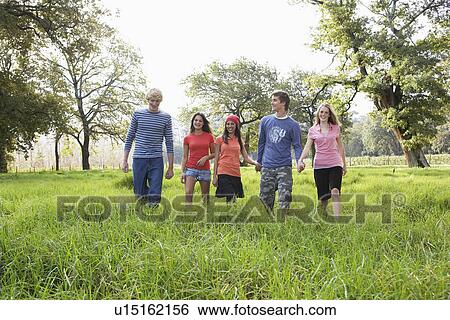 Five teenagers walking in field View Large Photo Image Stock Photograph - Five teenagers walking in field. Fotosearch