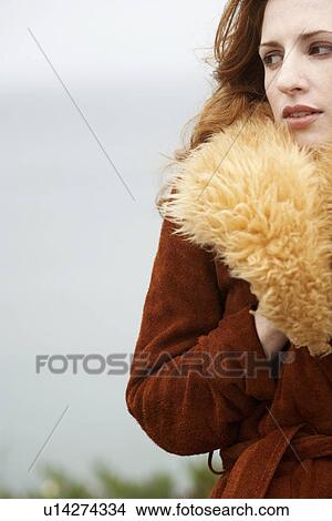 Picture - Woman in red coat. Fotosearch