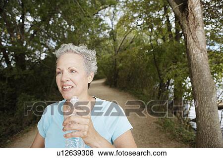 Woman jogging with water bottle View Large Photo Image Stock Photo - Woman jogging with water bottle. Fotosearch