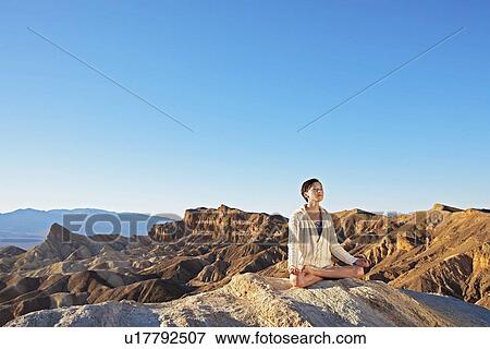 Woman Meditating in Lotus Position in Desert View Large Photo Image Stock Photo - Woman Meditating in Lotus Position in Desert. Fotosearch