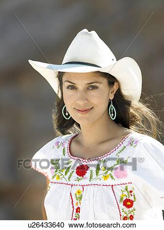 Stock Image - Woman wearing cowboy hats, portrait. Fotosearch