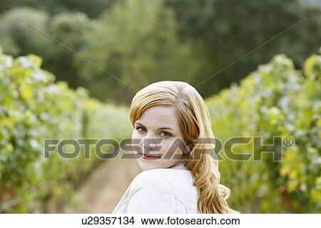 Young woman in vineyard (portrait) View Large Photo Image Picture - Young woman in vineyard (portrait). Fotosearch