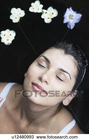 Flowers floating near woman's head (directly above) View Large Photo Image Stock Image - Flowers floating near woman's head (directly above). Fotosearch
