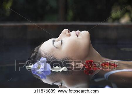 Flowers floating near woman's head View Large Photo Image Stock Photo - Flowers floating near woman's head. Fotosearch