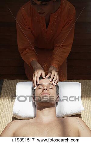 Stock Photo - Woman massaging man's head. Fotosearch
