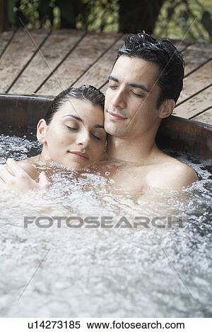 Young couple relaxing in Jacuzzi View Large Photo Image Stock Photography - Young couple relaxing in Jacuzzi. Fotosearch