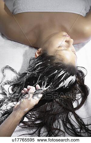 Stock Photography - Young woman receiving hair treatment. Fotosearch