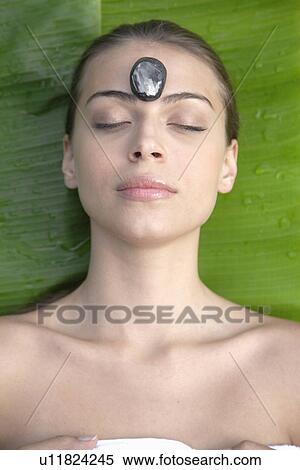 Young woman receiving hot stone therapy, directly above View Large Photo Image Stock Photography - Young woman receiving hot stone therapy, directly above. Fotosearch