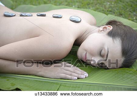 Young woman receiving hot stone therapy View Large Photo Image Stock Photograph - Young woman receiving hot stone therapy. Fotosearch
