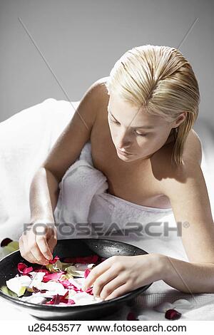 Young woman with bowl of rose water View Large Photo Image Stock Photo - Young woman with bowl of rose water. Fotosearch