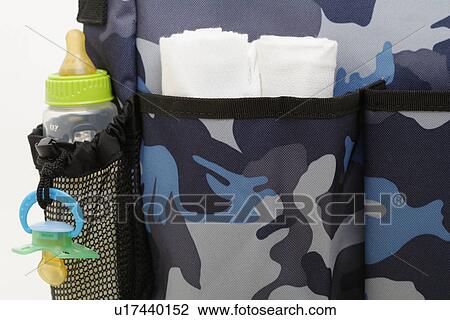 Baby bottle and diapers in pockets of baby carriage (close-up) View Large Photo Image Stock Image - Baby bottle and diapers in pockets of baby carriage (close-up). Fotosearch